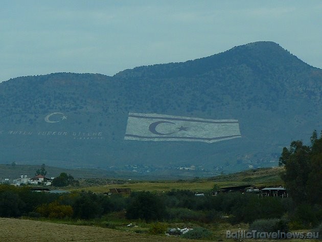 Ceļā uz Kipras salas galvaspilsētu pa logu paveras Ziemeļkipras Turku Republikas karogs 34728