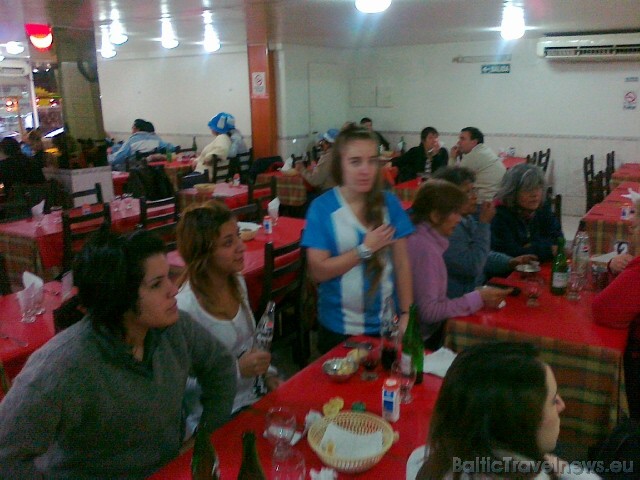 Buenosairesas kafejnīcās cilvēki ēd un vēro futbola spēli. Mobilā telefona foto: www.relaksture.lv 45634