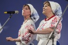 XXV Vispārējo latviešu dziesmu un XV deju svētku ietvaros pirmdien, 1. jūlijā, Lielajā Ģildē notika mazākumtautību kolektīvu koncertuzvedums Zem viena 25